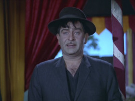 - Who are you?
- Isn't it enough for you that... I'm a human-being, who has two eyes, two ears, a nose, a stomach and... a heart? If you want, call me Raju, or Rajovsky.
- Why did you tell such an enormous lie?
- Should I say it in front of all? So listen... I told a big lie because we're past the age of small lies. It's the age of big lies. Women who apply paint and powder are considered beautiful. People who lie to the public are called leaders. In business, the bigger the lie you tell, the richer you are. In this field of big lies, I'm but a small player.
- Fool! Don't you realize you risked your life? The lions would've devoured you.
- Yes, I was scared. But in this world, there's something more scary. Poverty and hunger.