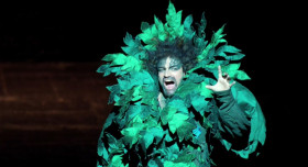 - He has a problem. A big one.
- Shush yourself.
- He’s a tree ... A singing tree. In German?
- Shush!
- Stop shushing me! It’s in German anyway. As if it wasn’t enough. You’re crazy. Oh man. How long does it last?
- Four hours.
- Damn.