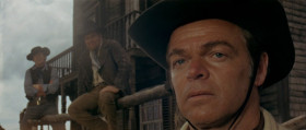- Didn't you get the idea? We don't like to see dummies like you in town. Where's your mule? You let him get away from you?
- That's what I want to talk to you about. He's feeling real bad.
- Who?
- My mule. He got all riled up when you men fired those shots at his feet. And now he refuses to be reasonable.
- Are you making some kind of joke?
- No. I understand that you men were just playing around, but the mule, he just doesn't get it. Of course, if you were to all apologize... I don't think it's nice you laughing. My mule doesn't like people laughing. He gets the crazy idea you're laughing at him. Now if you apologize, you'll get away with some kicks in the mouth.