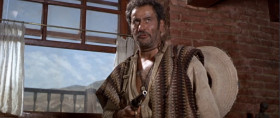 Now make sure the rope is tight. It's got to hold the weight of a pig. Now put the rope around your neck. That's very good. It's too big for your neck, huh? We fix that right away. I have another system. A little different than yours. I don't shoot the rope, I shoot the legs off the stool.
