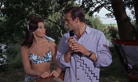 <b>Miss Moneypenny:</b> - Where in the world are you, James?
<b>James Bond:</b> - I've just been reviewing an old case.
<b>Sylvia Trench:</b> - So I'm an old case now, am I?
<b>James Bond:</b> - It's the office. Tell him I'm on my way, will you.
<b>Sylvia Trench:</b> - He is not on his way.
<b>James Bond:</b> - Sylvia, behave. We'll do this again some other time soon.
<b>Sylvia Trench:</b> - Do what? Last time you said that, you went off to Jamaica. I haven't seen you for six months.
<b>James Bond:</b> - I'll be there in an hour.
<b>Miss Moneypenny:</b> - I'll tell him. Your old case sounds interesting, James.
<b>James Bond:</b> - Make that an hour and a half.