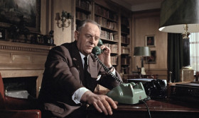 - M here.
- Leiter, sir. It's about 007, sir. We picked up his homer signal. It's monitored into Friendship Airport, Baltimore, where he's just landed.
- Baltimore? Nice of him to let us know. Last we heard, he was in Switzerland.
- He came in on a private jet, ex-Geneva, registered to our old friend, Auric Goldfinger.
- Well, I'm glad he's making progress. Keep an eye on him for us.
- Their flight plan gives Blue Grass Field, Kentucky, as their final destination.
- Don't charge in on him and spoil anything, will you? He's evidently well on top at the moment.