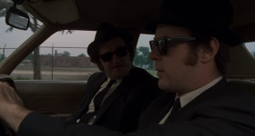 - What's this?
- What?
- This car. This stupid car. Where's the Cadillac? The Caddy. Where's the Caddy?
- The what?
- The Cadillac we used to have. The Bluesmobile.
- I traded it.
- You traded the Bluesmobile for this?
- No, for a microphone.
- A microphone? Okay, I can see that.