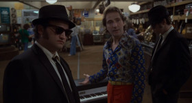 <b>Murph:</b> - Tell me a little about this electric piano, Ray.
<b>Ray:</b> - Oh, you have a good eye, my man. That's the best in the city of Chicago.
<b>Jake:</b> - How much?
<b>Ray:</b> - Two-thousand bucks and it's yours. You can take it home with you. Matter of fact, I'll throw in the black keys for free.