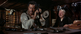 - Revolvers!
- Yeah, revolvers.
- Revolvers. Well, here's where I keep the best ones. Here, Remington, Colt, a Root, Smith-Wesson, Colt - navy, Joslyn, another Remington, and this one...
- That's enough.
- Cartridges.
- You wanna try the pistol, step out back.
- Cartridge. How much?
- Twenty dollars
- No.
- Fifty dollars.
- How much?
- A hundred dollars. Two hundred dollars. It's all I've got.