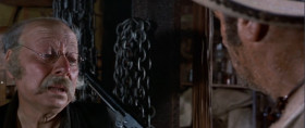 - Revolvers!
- Yeah, revolvers.
- Revolvers. Well, here's where I keep the best ones. Here, Remington, Colt, a Root, Smith-Wesson, Colt - navy, Joslyn, another Remington, and this one...
- That's enough.
- Cartridges.
- You wanna try the pistol, step out back.
- Cartridge. How much?
- Twenty dollars
- No.
- Fifty dollars.
- How much?
- A hundred dollars. Two hundred dollars. It's all I've got.