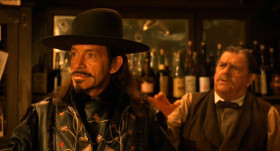 — Sign me up.
— No women in quick-draw. 
— There's no rules against ladies. It's just that women can't shoot for shit. Adíos, Reverend. Put 'em both in the contest.