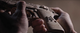 - Drop it.
- What, the tooth?
- No, not the tooth.
- I'm not dropping it.
- Well, it drops or you drop.
- This is a custom handmade Walther PPK that cost me nearly half a million dollars at auction.
- You bought a handgun for half a million dollars?
- And had my personal pistolsmith fit it with a vintage SD-22 SpielWaffen suppressor, of which there are six in the world, for an additional $250,000.
- 750,000 bucks?
- Correct.
- Why in the fuck, Pam, would you ever do something like that?
- Pam?
- Well, I never got your name so I just call you Pam.
- We've met?
- Many, many times, in passing. Let me see it. Slow. Hold it by the trigger guard.
- Handle it as if it were porcelain, please.
- Soft as a whisper. A.H.?
- Adolf, Hitler.
- Qué?
- It was a personal gift from Carl Walther. Hitler kept it in his desk in Munich.
- You've been killing me with fuckin' Hitler's gun this whole time?
- It was stolen by an American serviceman in 1945.
- Jesus, what is wrong with you?
- Fast-forward to present day...- a very pretty penny.
- I didn't think this could get any worse. And it has. Who sent you?
- Wouldn't you like to know.
- Hint, hint?
- Never. Are you gonna kill me now?
- No, Pam, I'm gonna shoot you. That's for the Jews. Those too.