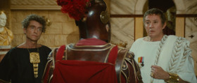 He's the only good chariot mechanic in this damn town. Why in Hades are we here except to please a brainless emperor! My nerves are shot to hell.
