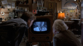 - Why, that's me! Look at me! I'm an old man! Thank God, I've still got my hair. What's this thing I'm wearing?
- This is a radiation suit.
- Radiation suit? Of course. 'Cause of all the fallout from the atomic wars.